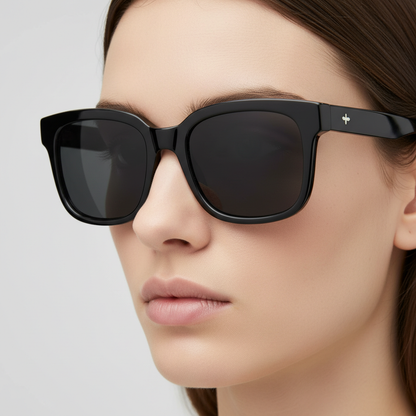 Black classic sunglasses worn by model closeup
